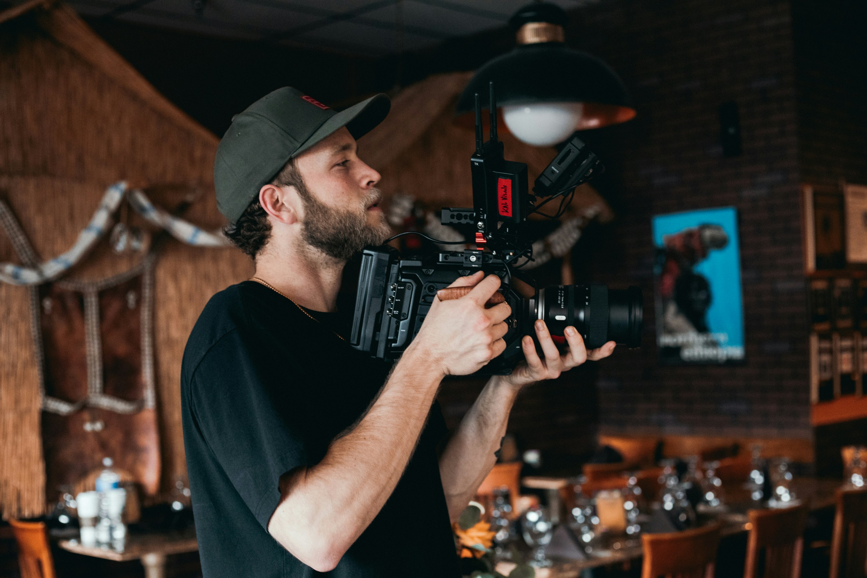 man in black crew neck t-shirt holding black dslr camera